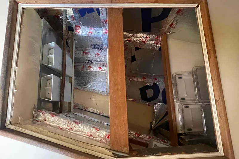 Slide: The Image of Interior view of 1989 Island Packet 35 sailboat with insulation and storage compartments. - 23