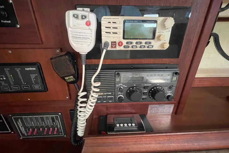 Slide: The Image of 1989 Island Packet 35 yacht radio and control panel with communication equipment. - 27