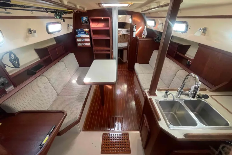 Slide: The Image of Interior of 1989 Island Packet 35 sailboat with cozy seating and wooden finishes. - 3