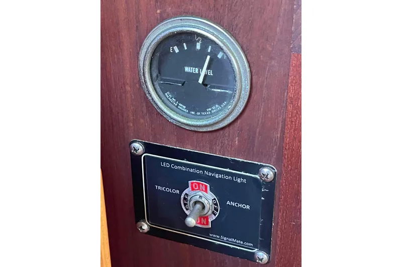 Slide: The Image of Control panel of 1989 Island Packet 35 with water level gauge and navigation light switch. - 32
