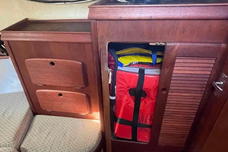 Slide: The Image of Interior storage of 1989 Island Packet 35 sailboat with life jackets and equipment. - 35