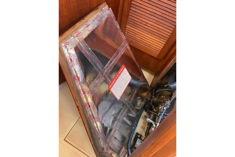 Slide: The Image of 1989 Island Packet 35 engine compartment with protective cover and visible components. - 51