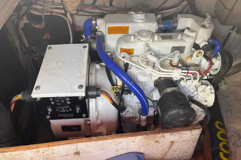 Slide: The Image of Engine compartment of a 1989 Island Packet 35 sailboat, featuring detailed mechanical components. - 52