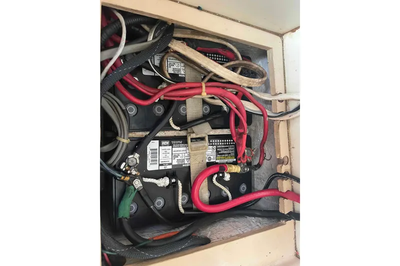 Slide: The Image of Battery compartment with wiring in a 1989 Island Packet 35 sailboat. - 55