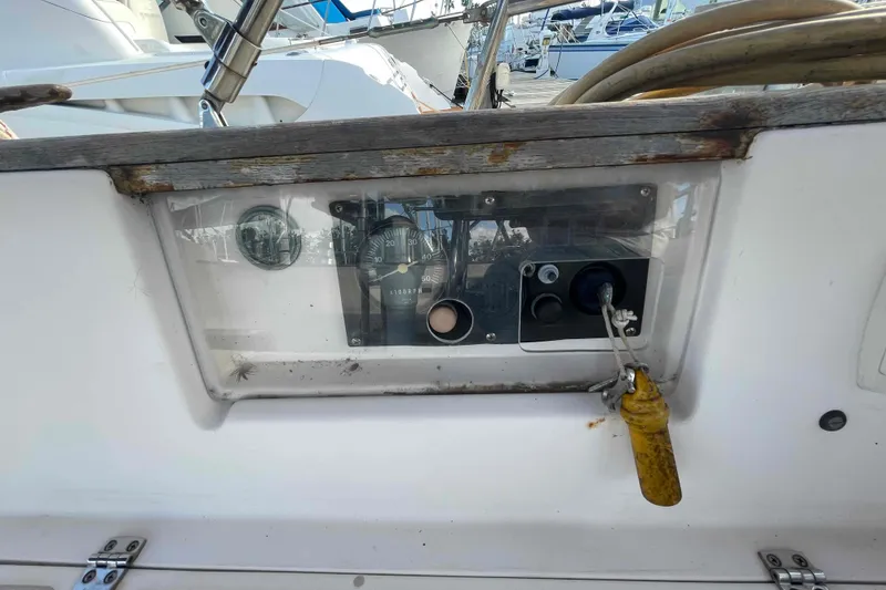 Slide: The Image of 1989 Island Packet 35 sailboat cockpit with control panel and steering wheel. - 63