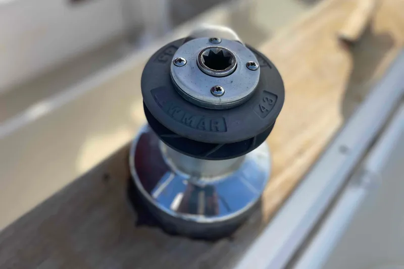 Slide: The Image of Cockpit of 1989 Island Packet 35 sailboat docked at marina, featuring steering wheel and seating. - 66