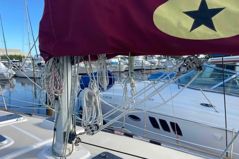 Slide: The Image of Folded sail on 1989 Island Packet 35 sailboat against a blue sky background. - 72