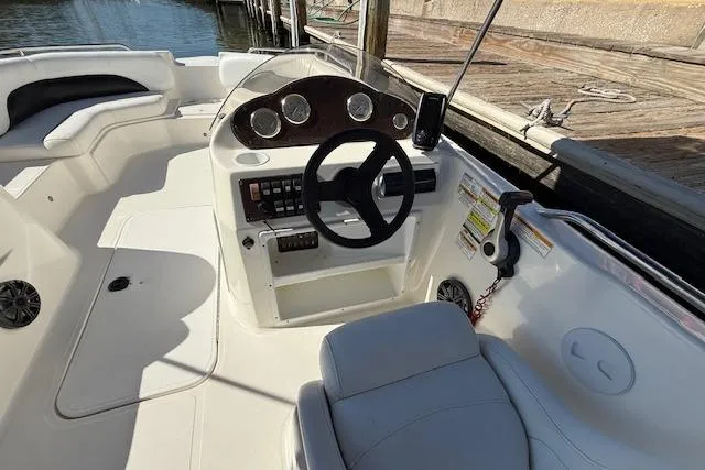 Slide: The Image of 2011 Hurricane SunDeck Sport 201 OB boat interior with steering wheel and seating. - 17