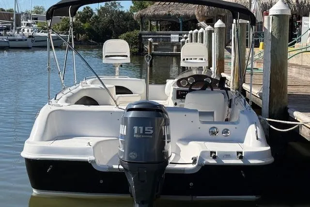 Slide: The Image of 2011 Hurricane SunDeck Sport 201 OB boat docked, featuring Yamaha 115 outboard motor. - 25