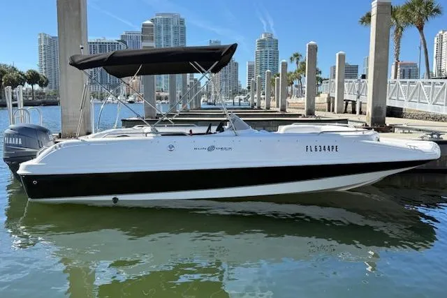 The Image of 2011 Hurricane SunDeck Sport 201 OB boat docked in marina, city skyline in background. - 7