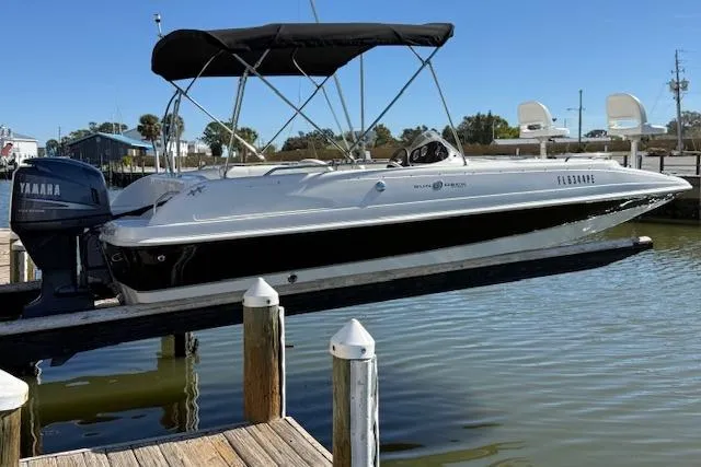 Slide: The Image of 2011 Hurricane SunDeck Sport 201 OB boat docked with Yamaha outboard motor. - 9