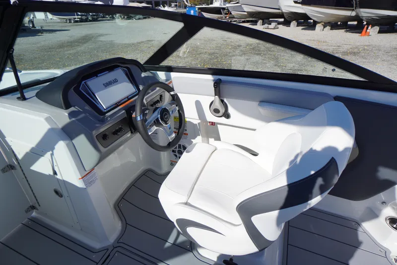 Slide: The Image of 2026 Chaparral 21 SSi OB boat interior with steering wheel and dashboard display. - 17