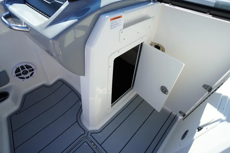 Slide: The Image of 2026 Chaparral 21 SSi OB boat interior with open storage compartment and sleek design. - 25