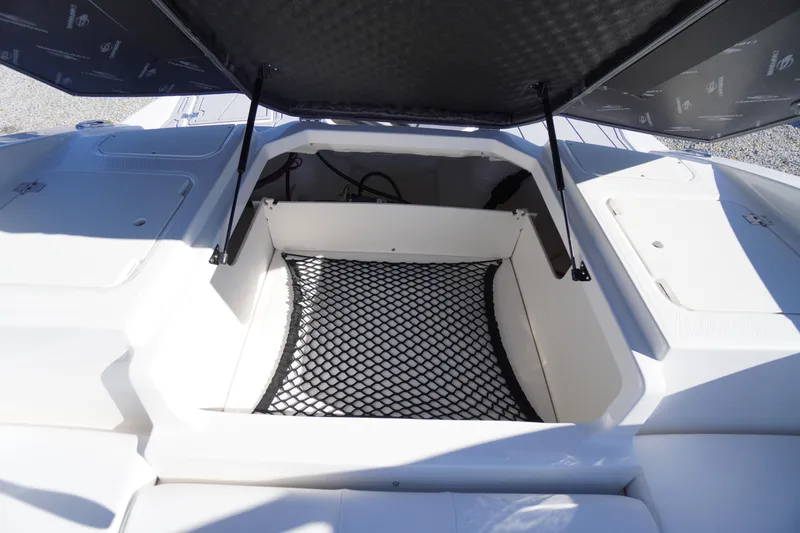 Slide: The Image of Open storage compartment on 2026 Chaparral 21 SSi OB boat with netting. - 45