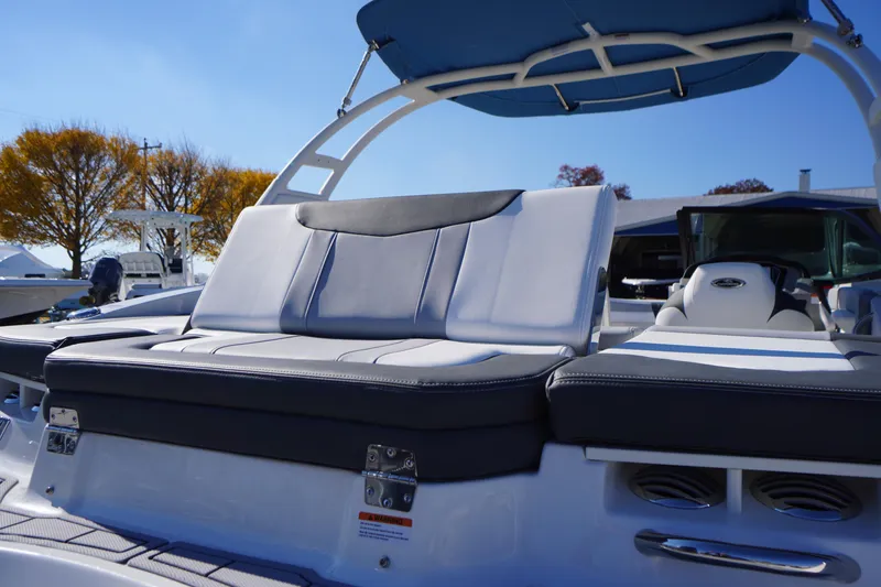 Slide: The Image of 2026 Chaparral 21 SSi OB boat with sleek seating and canopy, set against a clear sky. - 48