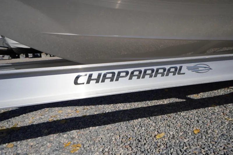 Slide: The Image of Chaparral 21 SSi OB 2026 boat logo on trailer, gravel background. - 56