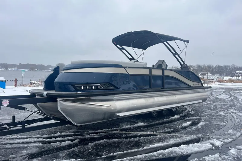 Slide: The Image of 2026 Harris Grand Mariner 230 pontoon boat on snowy lakeside, showcasing sleek design. - 3