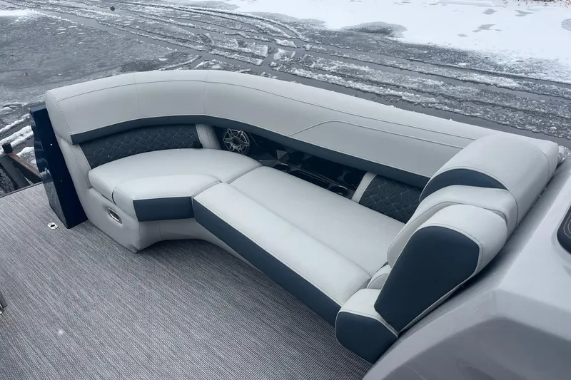 Slide: The Image of 2026 Harris Grand Mariner 230 boat interior with luxurious seating on snowy dock. - 9
