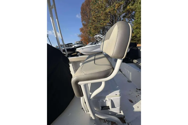 Slide: The Image of 2023 Key West 203 FS boat seat with beige upholstery, outdoor setting. - 10
