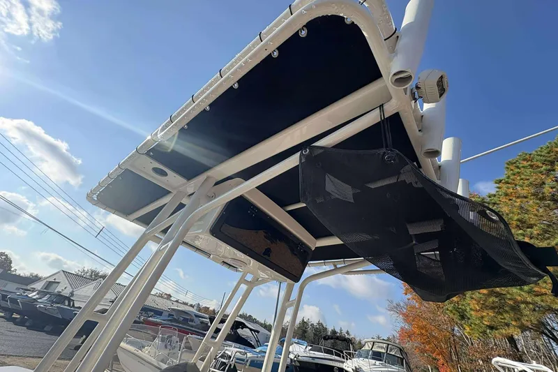 Slide: The Image of 2023 Key West 203 FS boat with T-top under clear blue sky. - 14