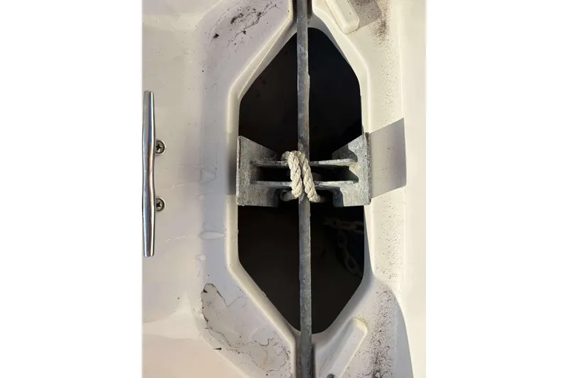 Slide: The Image of Anchor storage compartment on 2023 Key West 203 FS boat, featuring a secured anchor and rope. - 16