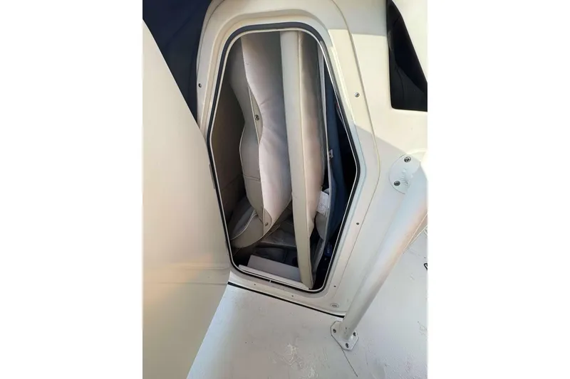 Slide: The Image of 2023 Key West 203 FS boat storage compartment with cushioned interior. - 17