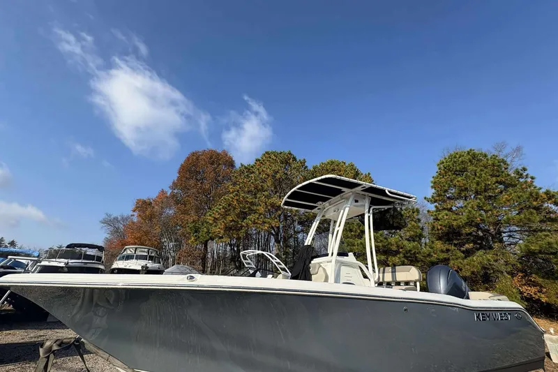 Slide: The Image of 2023 Key West 203 FS boat parked outdoors under clear blue sky. - 2