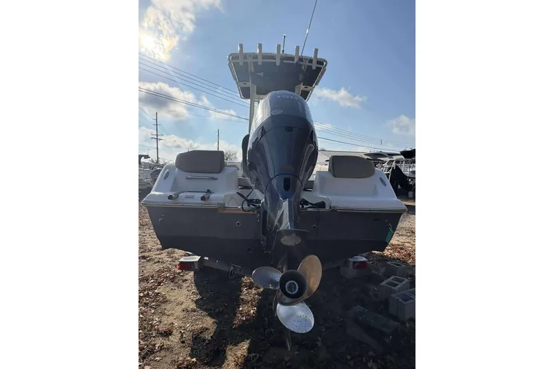 Slide: The Image of 2023 Key West 203 FS boat rear view with outboard motor and clear sky. - 20