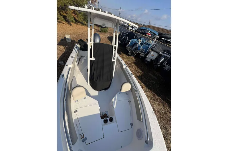 Slide: The Image of 2023 Key West 203 FS boat with T-top, parked outdoors. - 6