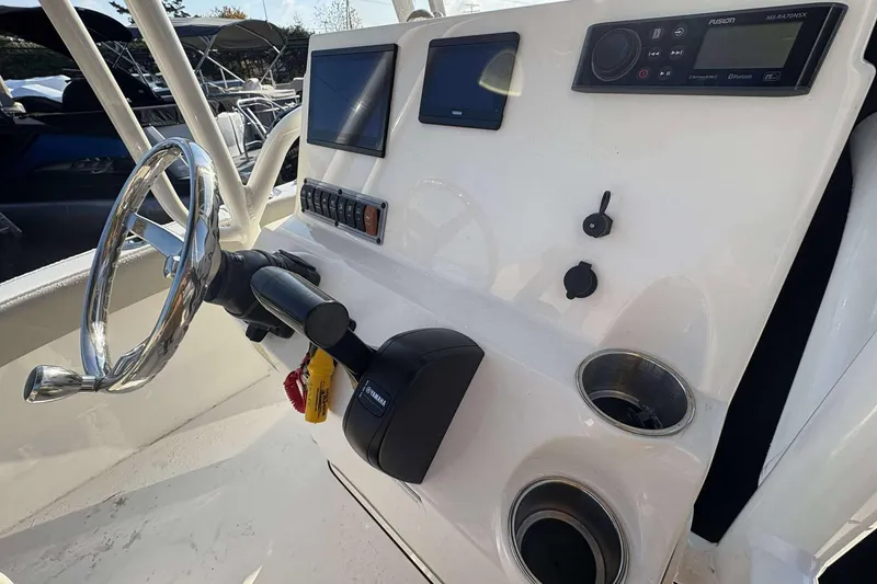 Slide: The Image of 2023 Key West 203 FS boat console with steering wheel, controls, and display screens. - 8