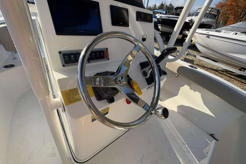Slide: The Image of 2023 Key West 203 FS boat dashboard with steering wheel and control panel. - 9