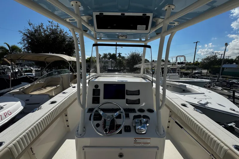 Slide: The Image of 2019 Sea Chaser 27 HFC boat cockpit with steering wheel and control panel. - 13