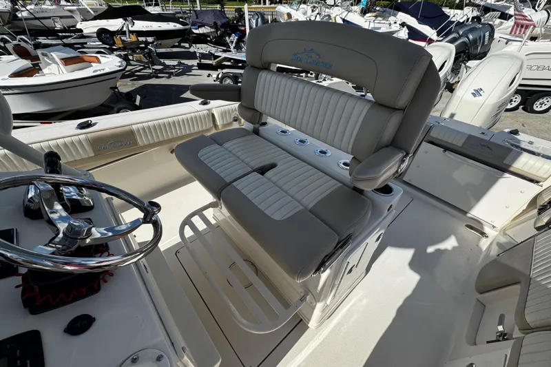 Slide: The Image of 2019 Sea Chaser 27 HFC boat interior with steering wheel and cushioned seating. - 14