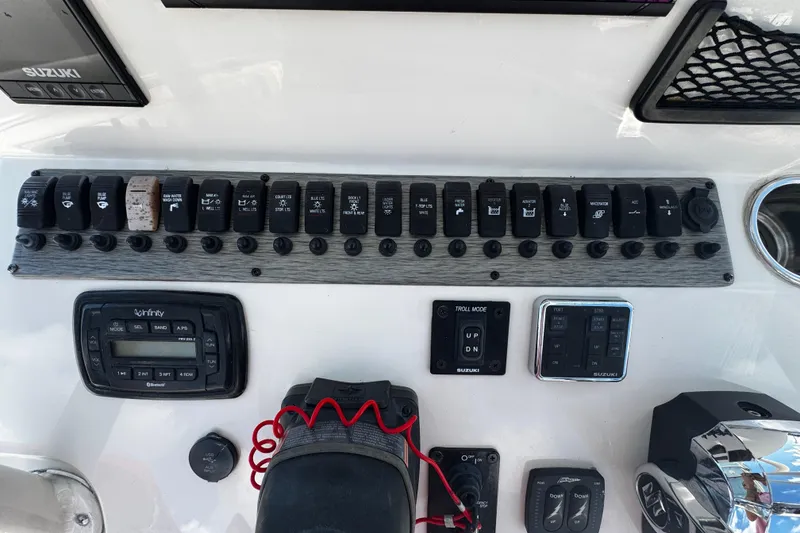 Slide: The Image of Control panel of a 2019 Sea Chaser 27 HFC boat with various switches and controls. - 15