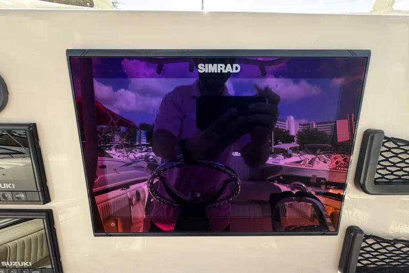 Slide: The Image of Simrad display on 2019 Sea Chaser 27 HFC boat dashboard with reflection. - 16