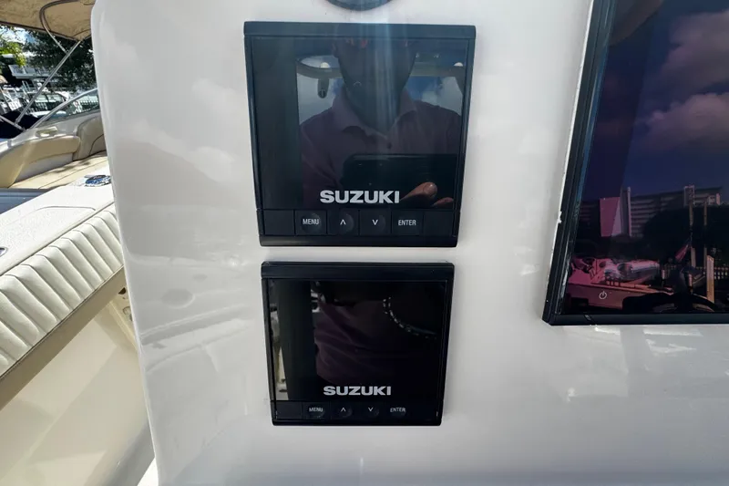 Slide: The Image of 2019 Sea Chaser 27 HFC boat dashboard with dual Suzuki displays. - 17