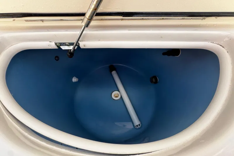 Slide: The Image of Livewell interior of 2019 Sea Chaser 27 HFC boat, featuring blue lining and lid support. - 24