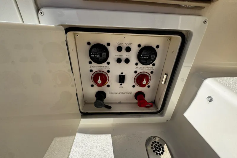 Slide: The Image of Control panel of a 2019 Sea Chaser 27 HFC boat, featuring battery switches. - 26