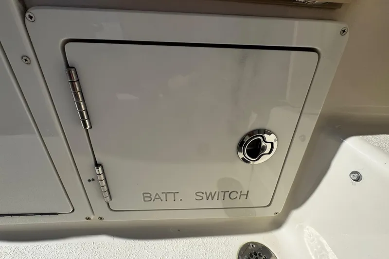 Slide: The Image of Battery switch compartment on a 2019 Sea Chaser 27 HFC boat. - 27