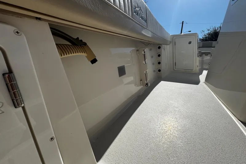 Slide: The Image of 2019 Sea Chaser 27 HFC boat interior, showcasing clean deck and storage compartments. - 29