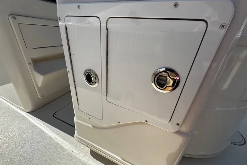 Slide: The Image of 2019 Sea Chaser 27 HFC boat storage compartment with chrome handles. - 32