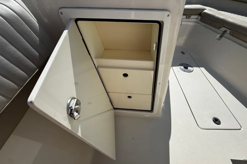 Slide: The Image of 2019 Sea Chaser 27 HFC boat storage compartment with open door and drawers. - 10