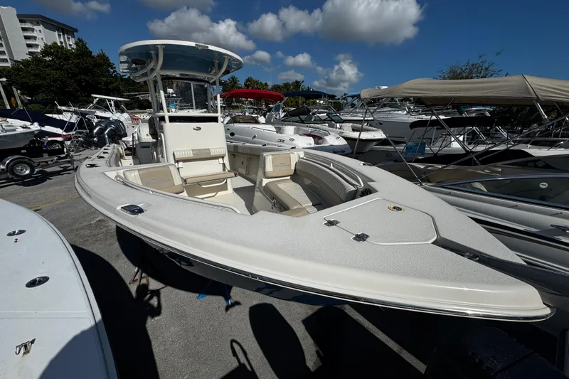 Slide: The Image of 2019 Sea Chaser 27 HFC boat displayed in a marina under a clear blue sky. - 2