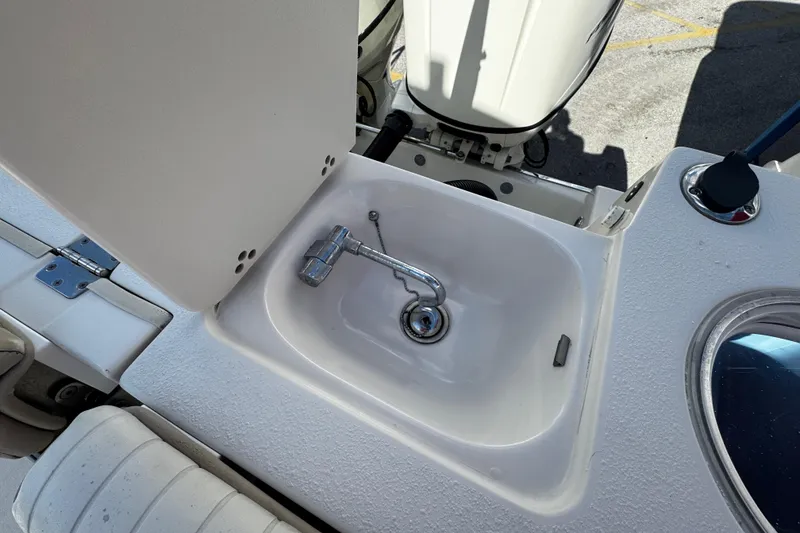 Slide: The Image of 2019 Sea Chaser 27 HFC boat sink with faucet and storage compartment. - 33
