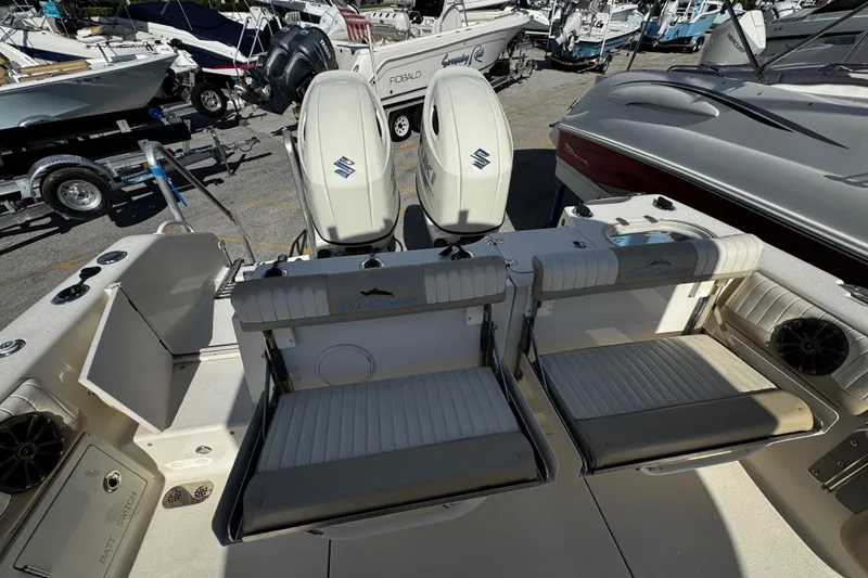 Slide: The Image of 2019 Sea Chaser 27 HFC boat with dual Suzuki outboard engines and seating area. - 35