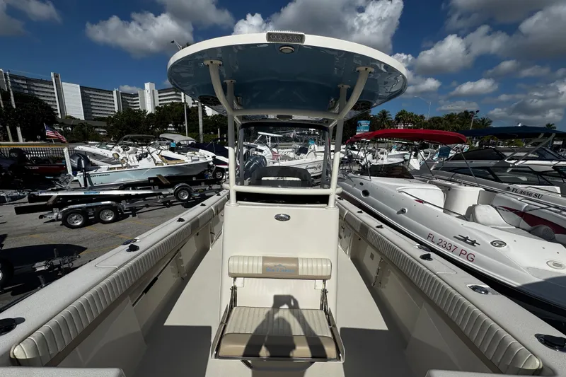 Slide: The Image of 2019 Sea Chaser 27 HFC boat at marina, surrounded by other vessels under a blue sky. - 6