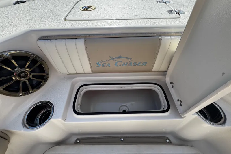 Slide: The Image of 2019 Sea Chaser 27 HFC boat interior with storage compartment and speaker. - 8
