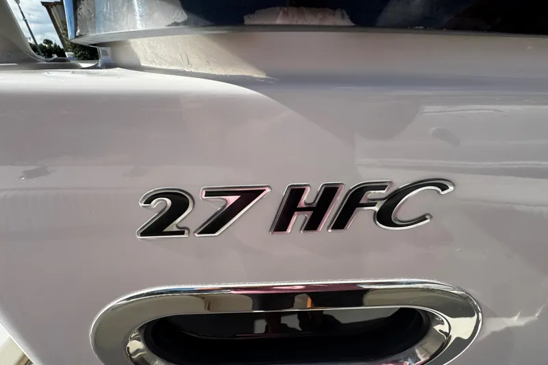 Slide: The Image of 2019 Sea Chaser 27 HFC boat emblem on sleek white surface. - 9