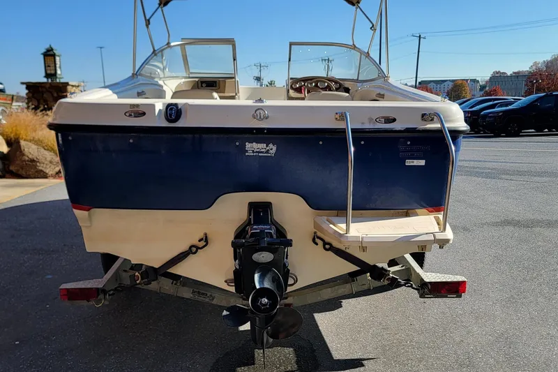 Slide: The Image of 2004 Bayliner 215 Classic boat rear view with outboard motor and swim platform. - 3