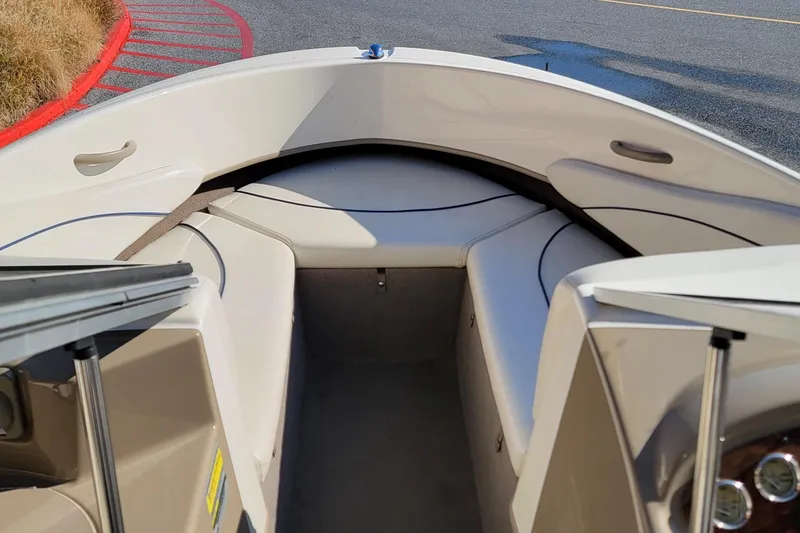 Slide: The Image of 2004 Bayliner 215 Classic boat interior with cushioned seating and open bow design. - 4